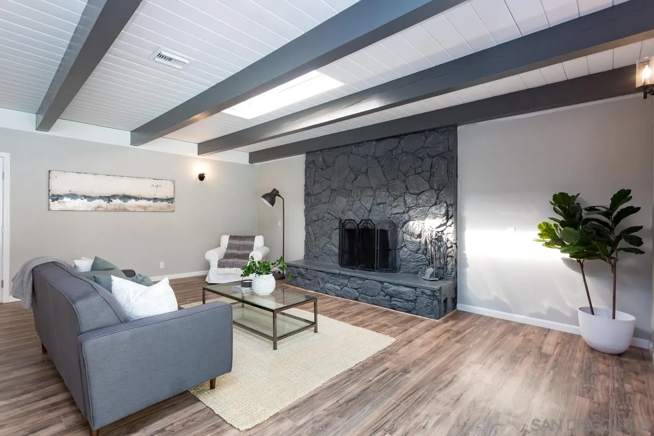 9597 Mandeville Road Santee, CA 92071 - Photo 5 of 32 a living room with furniture a potted plant and a fireplace