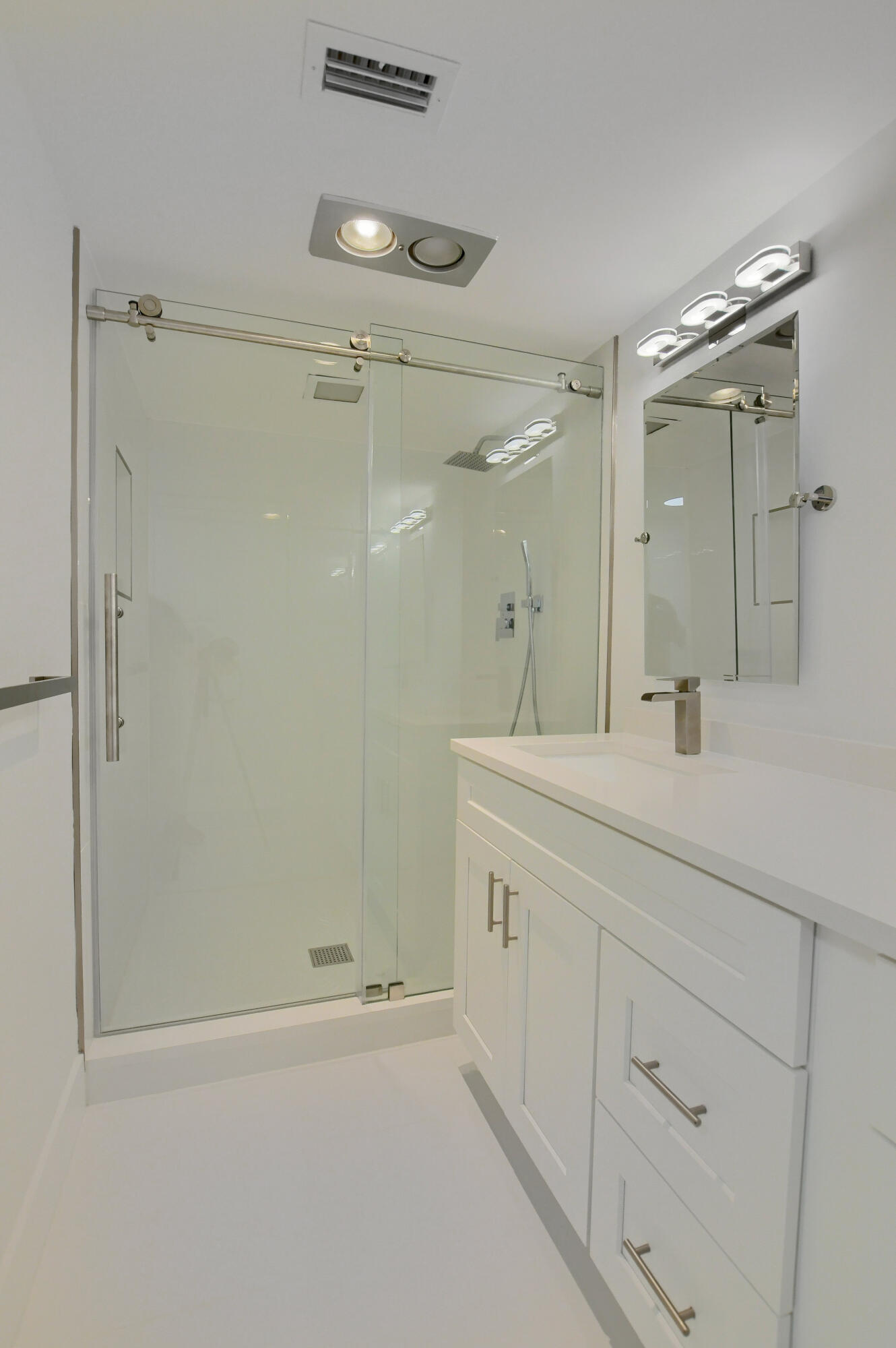 9170 Southwest 14th Street, Unit 4405 Boca Raton, FL 33428 - Photo 18 of 48 a bathroom with a shower sink and mirror
