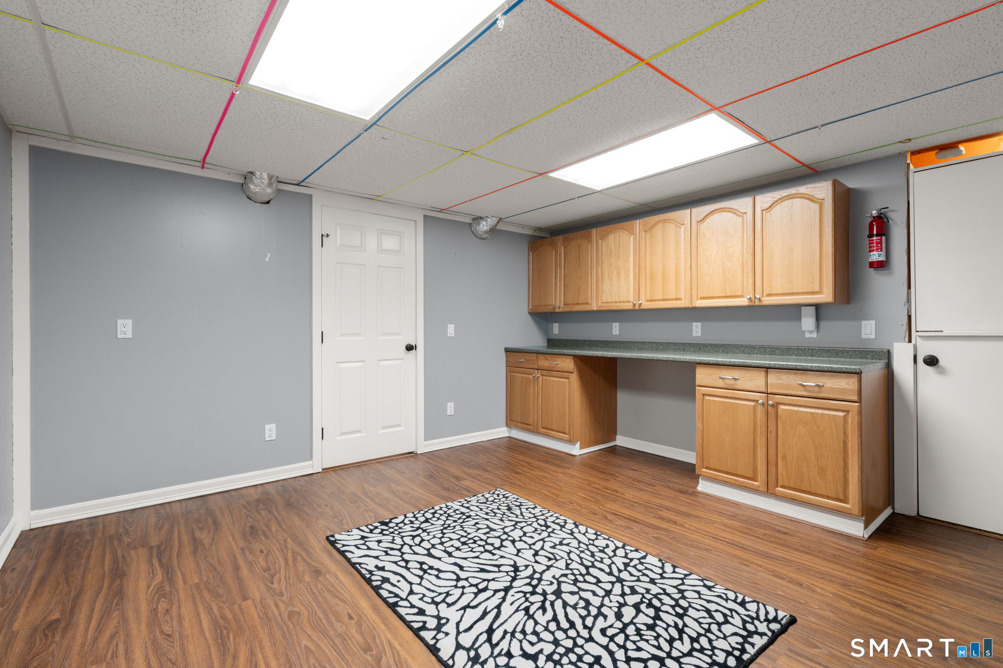 141 Briar Hill Road Groton, CT 06340 - Photo 37 of 40 2nd finished room in the basement with flooring & cabinets. Playroom, office so many potential uses!