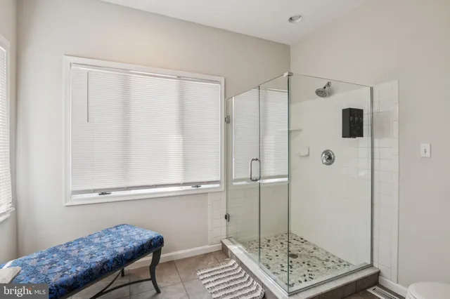 a bedroom with a large bed and a large window