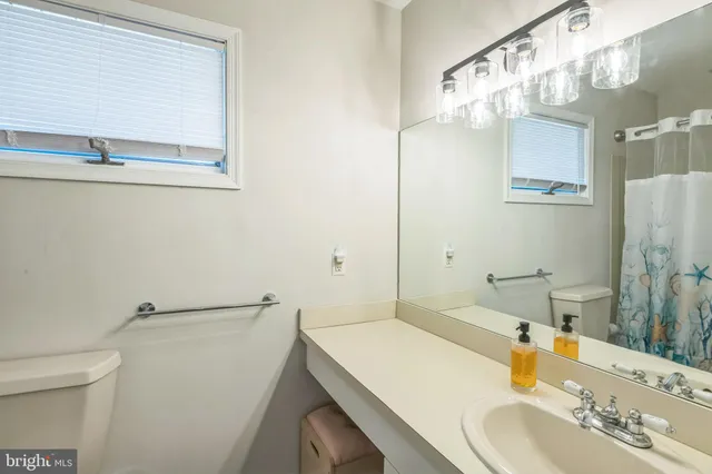 a bathroom with a sink vanity and a mirror