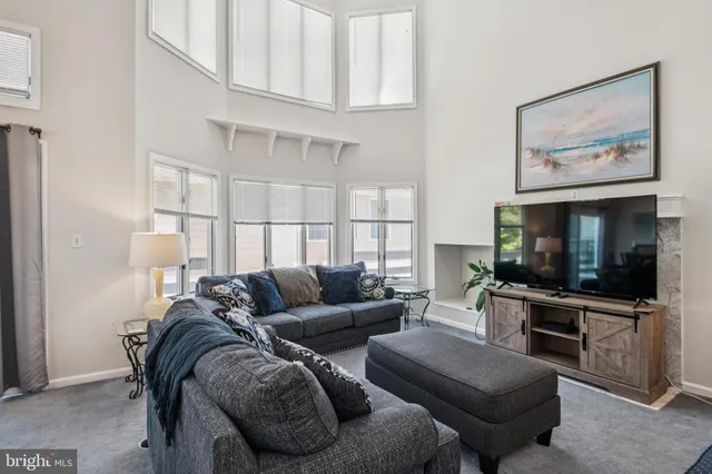 a living room with furniture windows and a chandelier