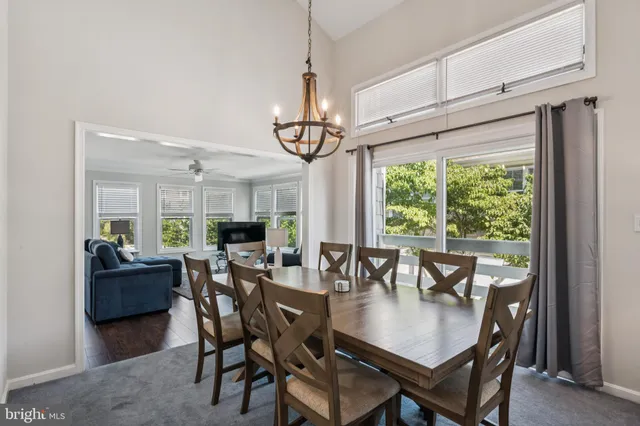 a living room with furniture a flat screen tv and a wall clock