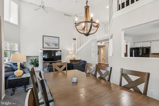 a living room with furniture a flat screen tv and a window
