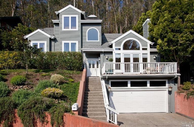 a front view of a house with a yard garage and outdoor seating