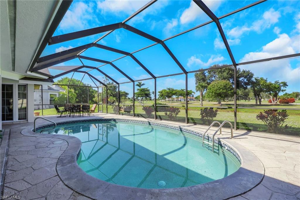 369 Hidden Valley Drive Naples, FL 34113 - Photo 11 of 49 a view of a swimming pool with a porch