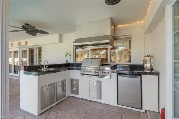 a kitchen with stainless steel appliances granite countertop a sink and cabinets