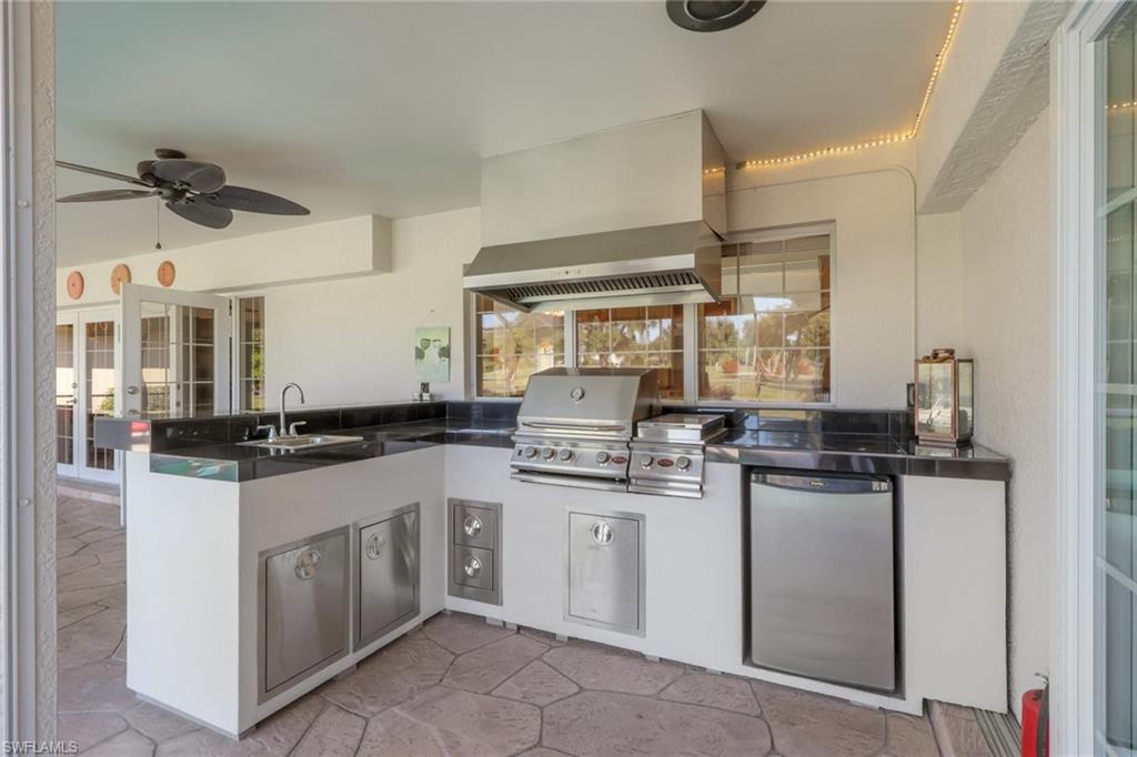 369 Hidden Valley Drive Naples, FL 34113 - Photo 20 of 49 a kitchen with stainless steel appliances granite countertop a sink and cabinets