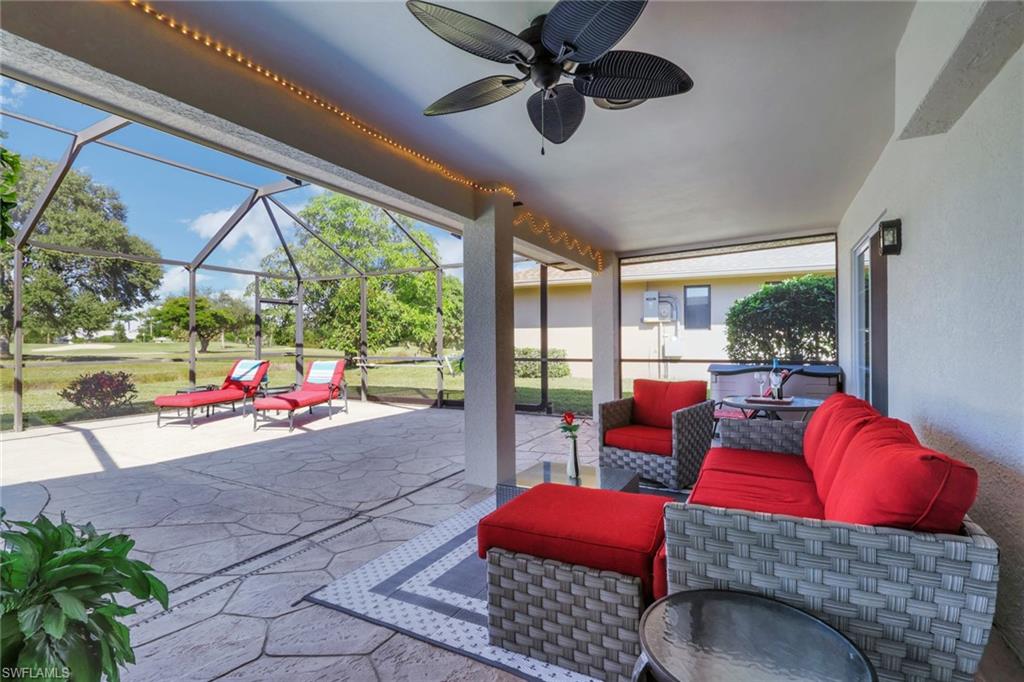 369 Hidden Valley Drive Naples, FL 34113 - Photo 21 of 49 a living room with furniture and a floor to ceiling window