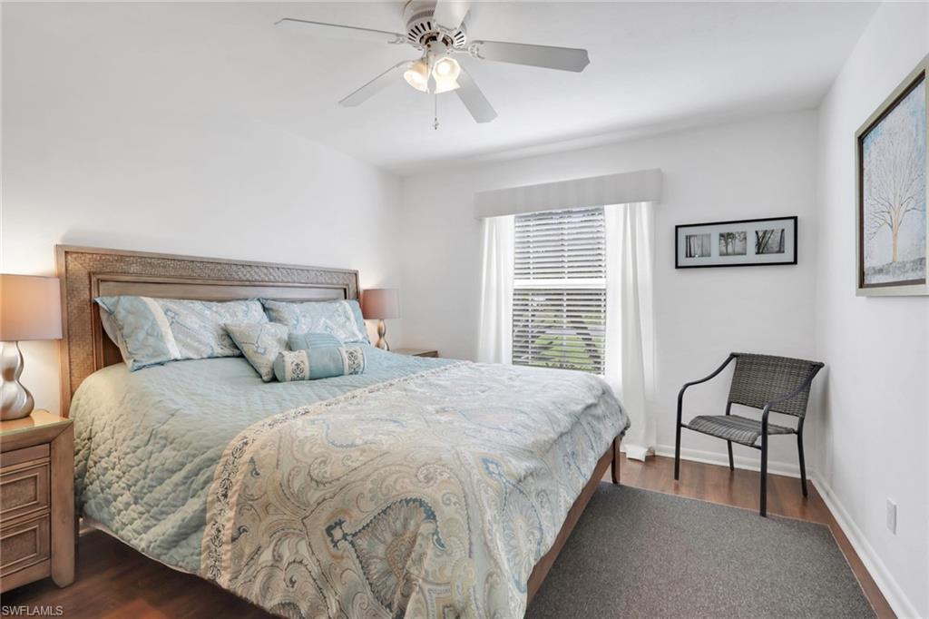 369 Hidden Valley Drive Naples, FL 34113 - Photo 23 of 49 a bedroom with a bed and a chandelier