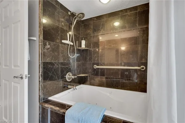 a bathroom with a bathtub and shower