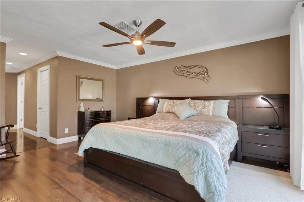 369 Hidden Valley Drive Naples, FL 34113 - Photo 31 of 49 a bedroom with a bed and a mirror