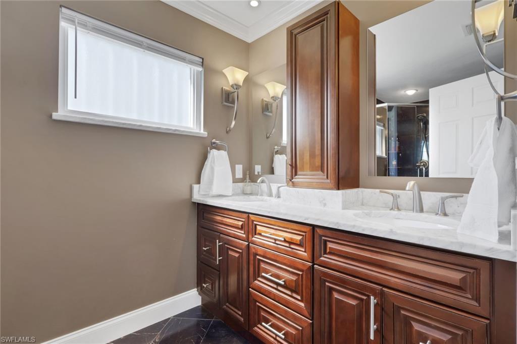 369 Hidden Valley Drive Naples, FL 34113 - Photo 32 of 49 a bathroom with a sink and a mirror