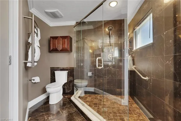 a bathroom with a toilet a sink and shower