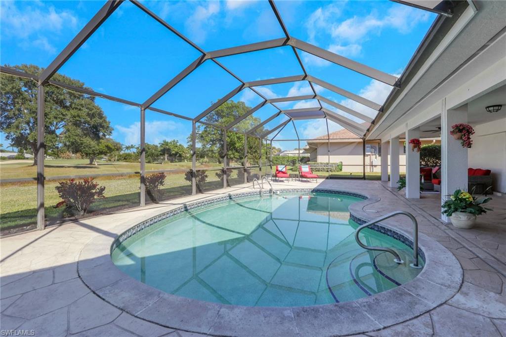 369 Hidden Valley Drive Naples, FL 34113 - Photo 35 of 49 a view of a swimming pool with a patio