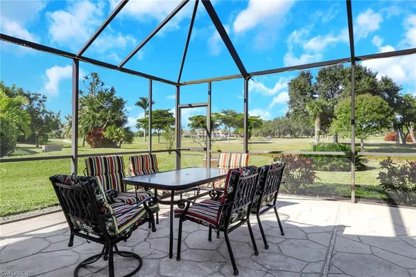 a view of a chair and table in the patio