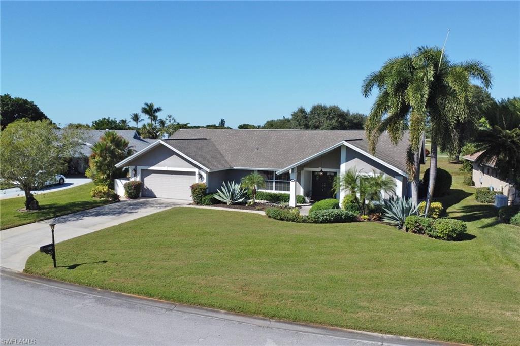 369 Hidden Valley Drive Naples, FL 34113 - Photo 38 of 49 a front view of a house with a yard