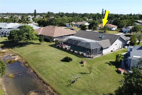 an aerial view of a house with swimming pool and garden