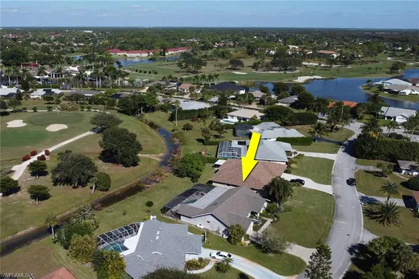 an aerial view of a houses with a swimming pool