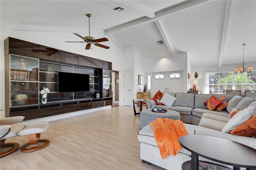 369 Hidden Valley Drive Naples, FL 34113 - Photo 8 of 49 a living room with furniture and a flat screen tv