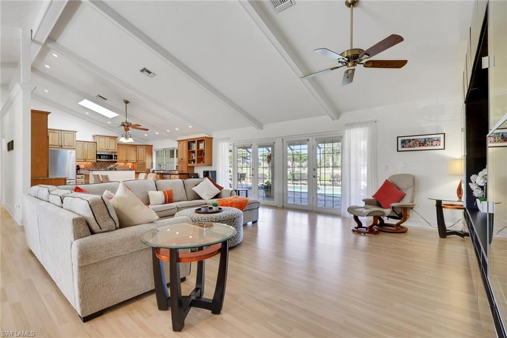 369 Hidden Valley Drive Naples, FL 34113 - Photo 10 of 49 a living room with furniture and a wooden floor
