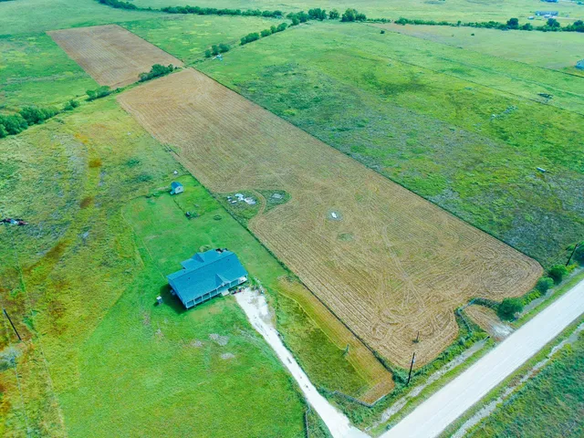 an aerial view of a house with a yard