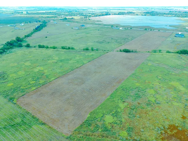 a view of a field with an ocean