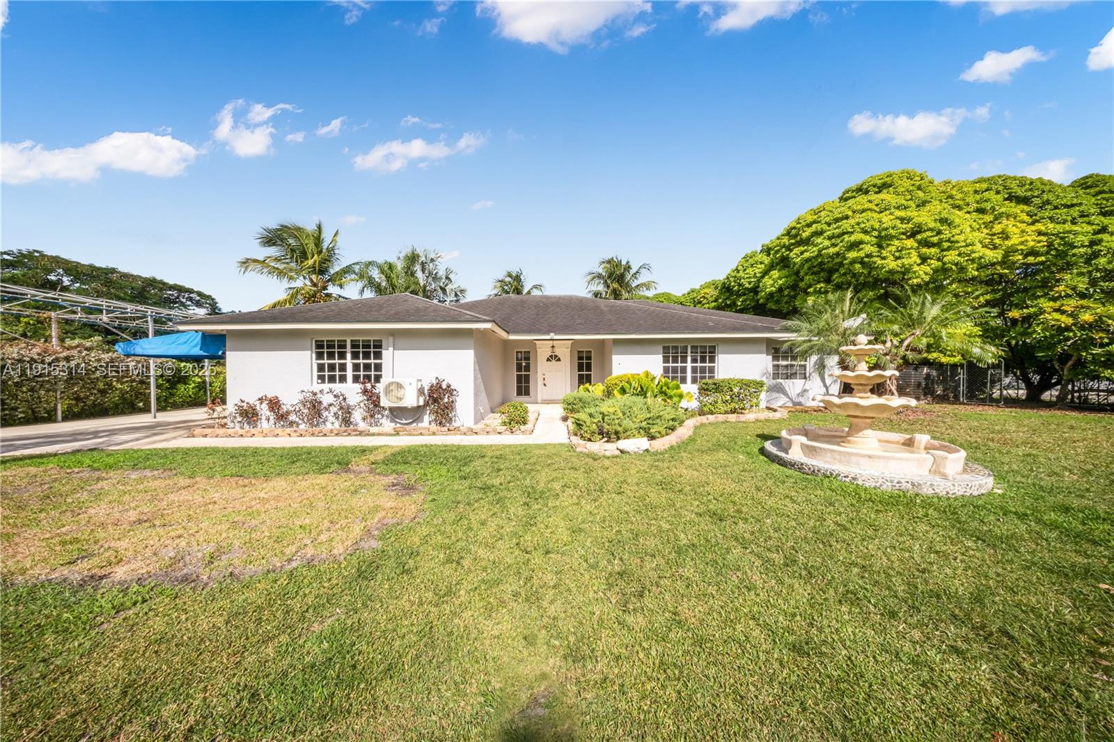 a front view of a house with swimming pool having outdoor seating