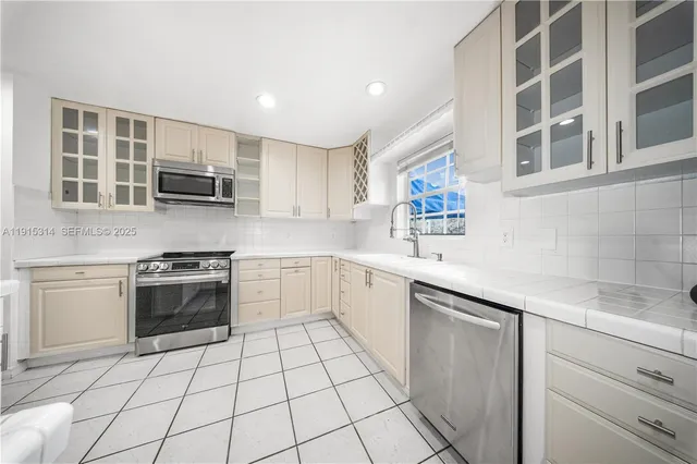 a kitchen with a stove a sink and a microwave