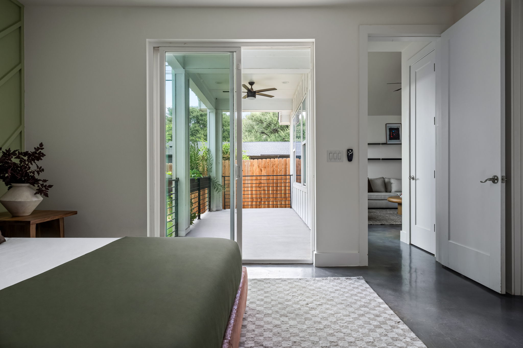 1902 Webberville Road, Unit B Austin, TX 78721 - Photo 19 of 39 Sliding glass doors open to a private balcony, extending the living space outdoors.