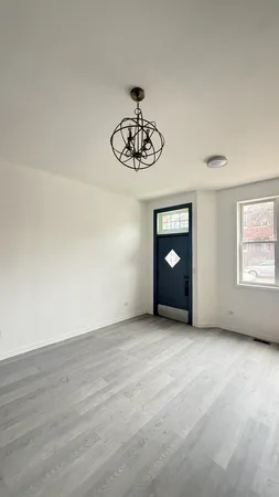 a view of an empty room with a window and a table