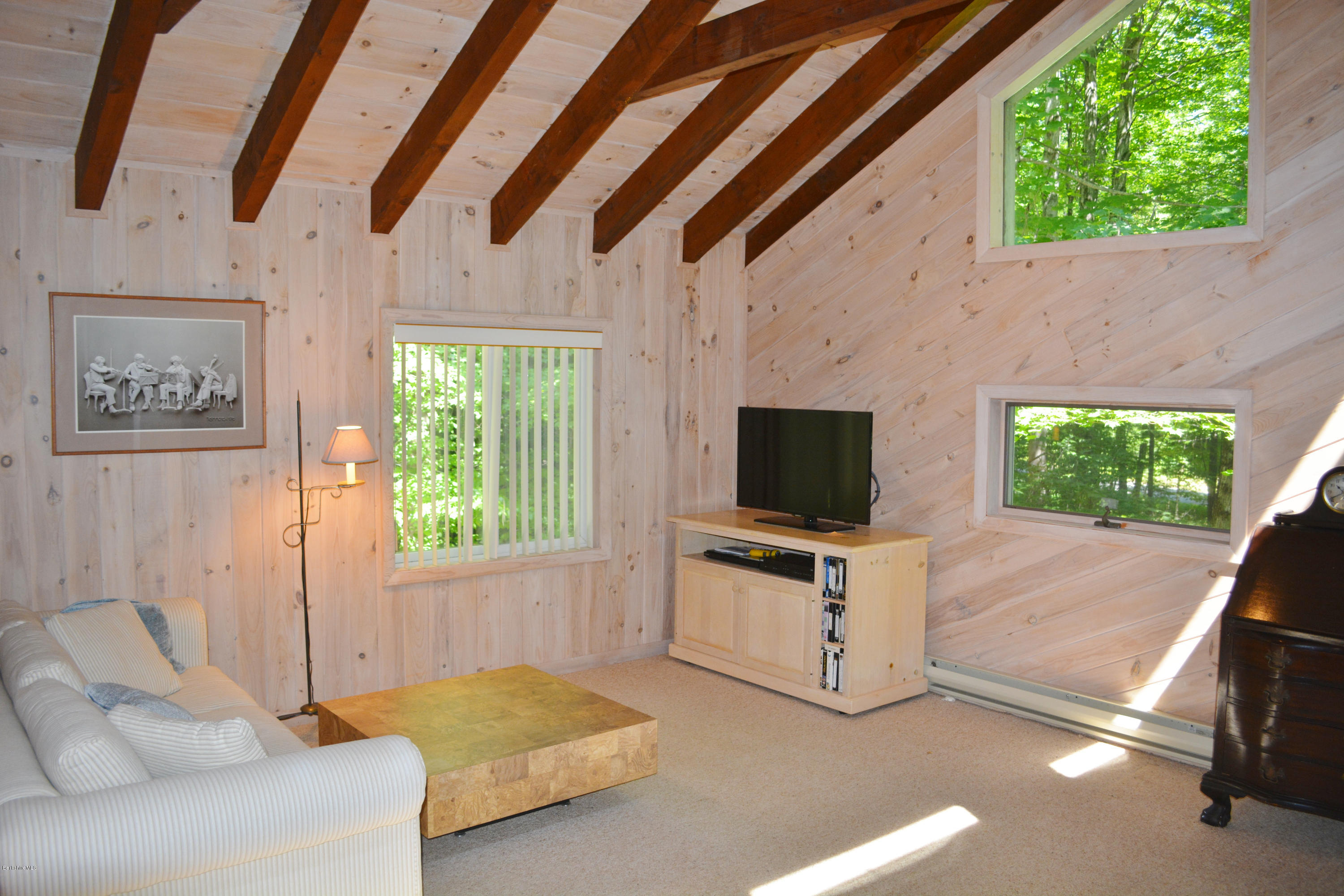894 Moberg Road Becket, MA 01223 - Photo 11 of 21 a living room with furniture and a flat screen tv