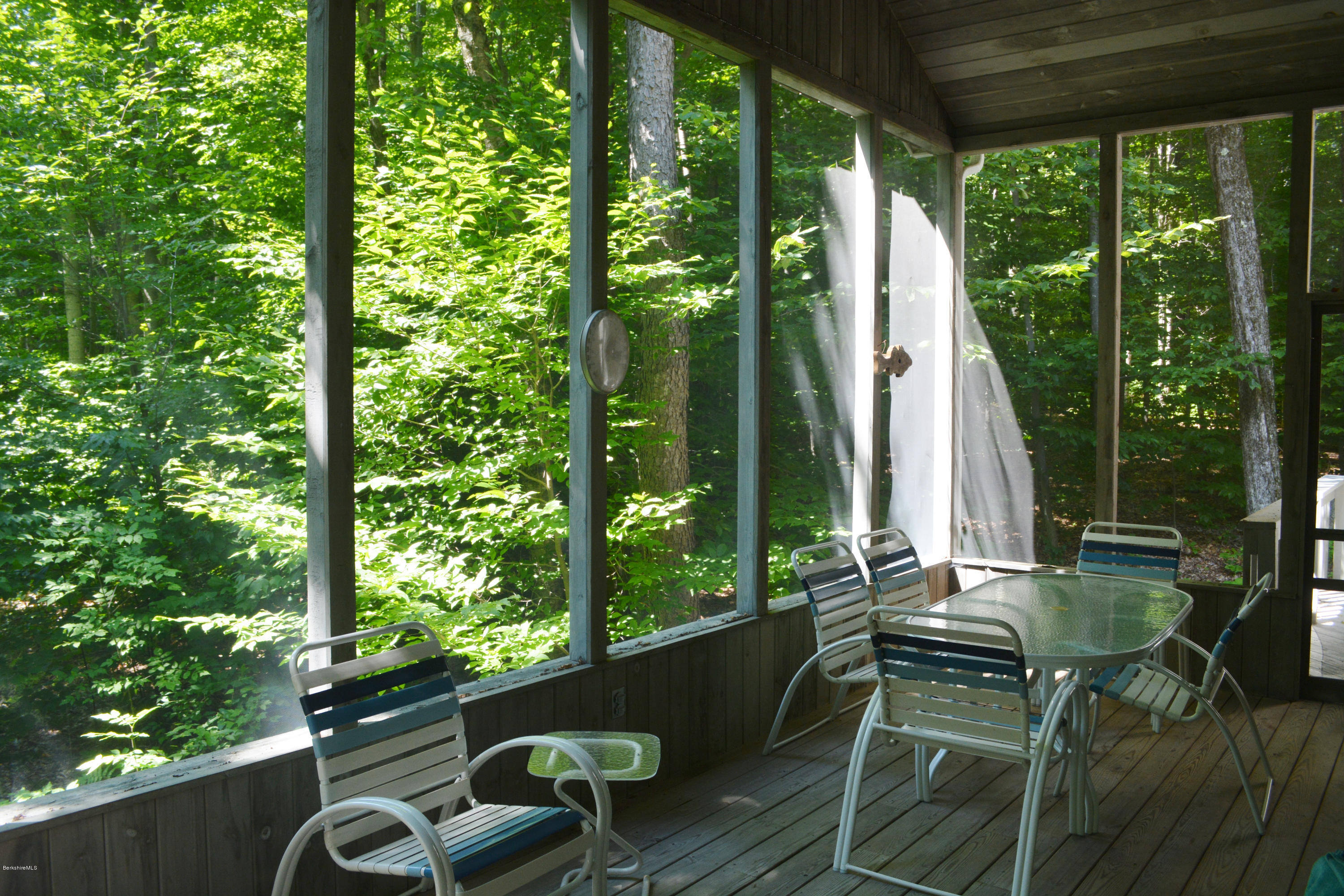 894 Moberg Road Becket, MA 01223 - Photo 14 of 21 a patio with yard glass top table and chairs