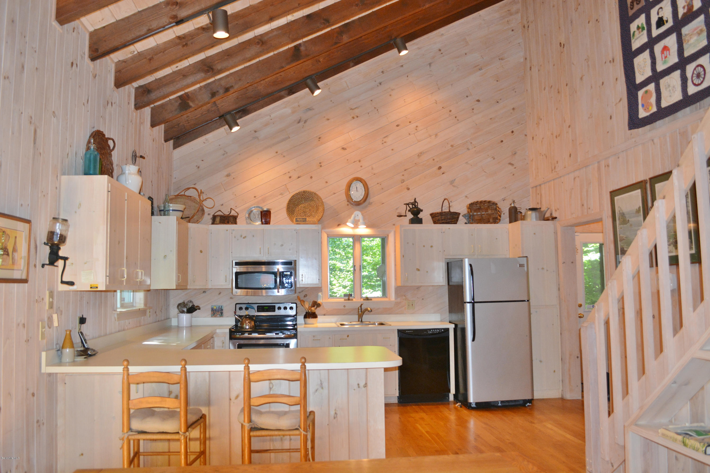894 Moberg Road Becket, MA 01223 - Photo 5 of 21 a kitchen with stainless steel appliances a refrigerator and a stove top oven