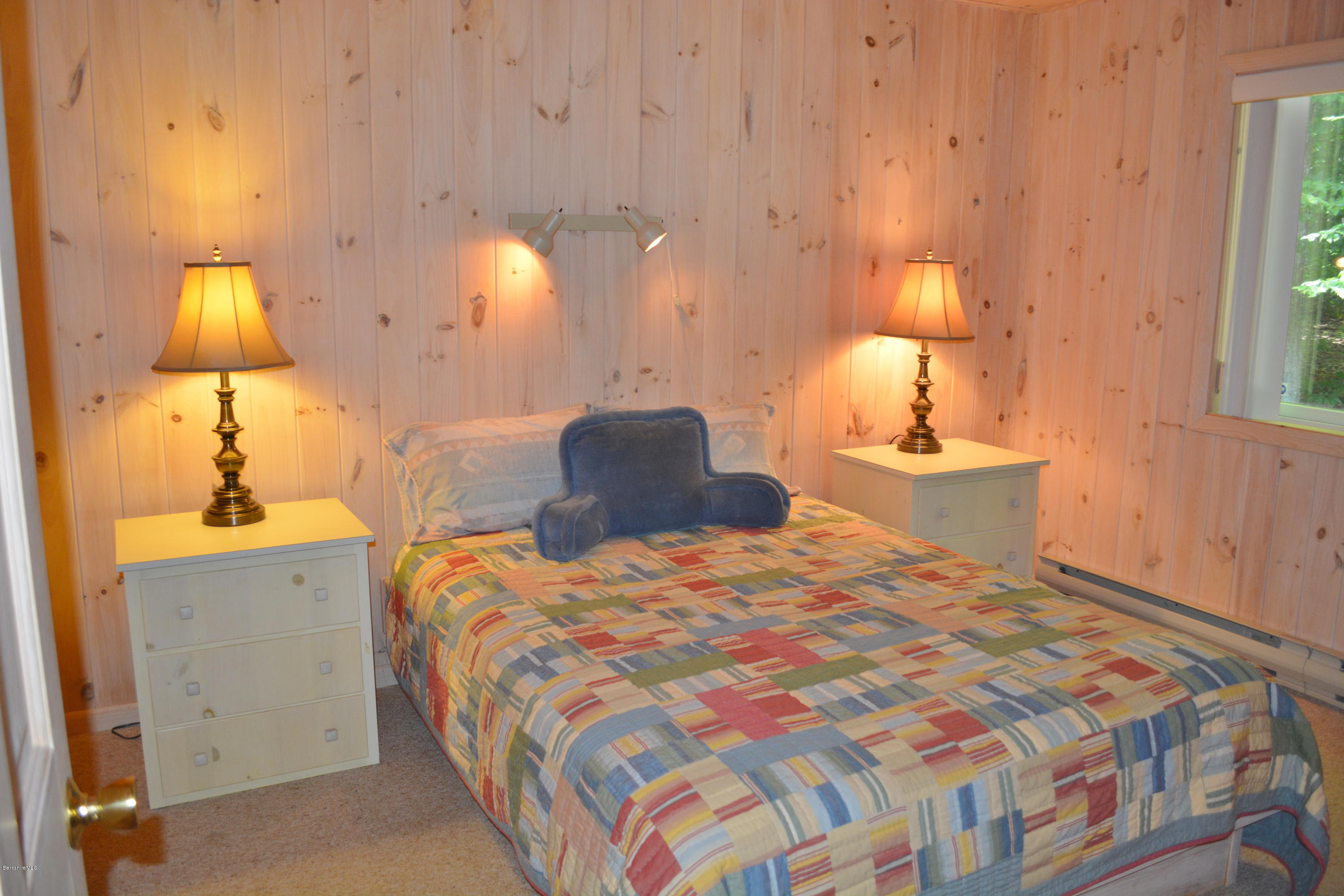 894 Moberg Road Becket, MA 01223 - Photo 10 of 21 a bedroom with a bed and a lamp