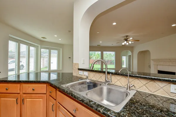 a kitchen with granite countertop a sink and a window
