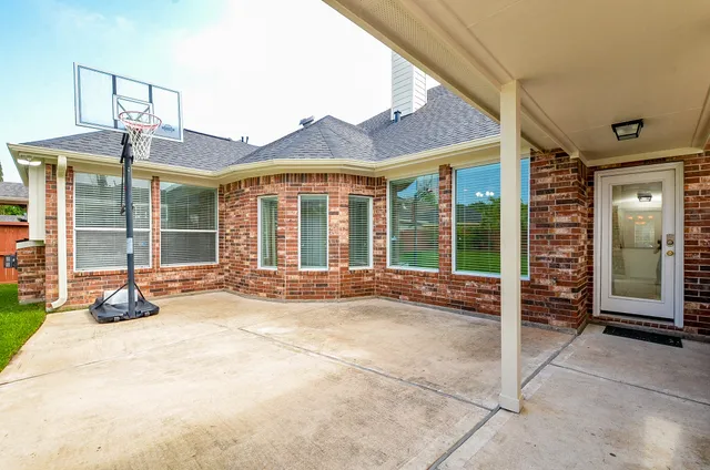 a view of a house with a yard and sitting area