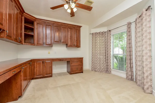a kitchen with a cabinets and chandelier