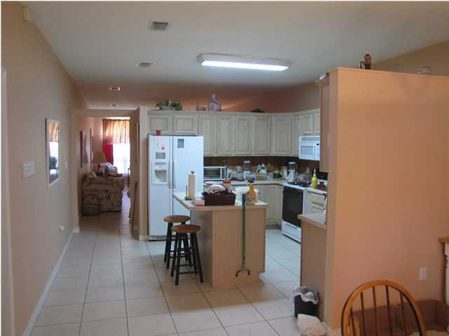 64 Windy Way Santa Rosa Beach, FL 32459 - Photo 5 of 20 a kitchen with a refrigerator and a table