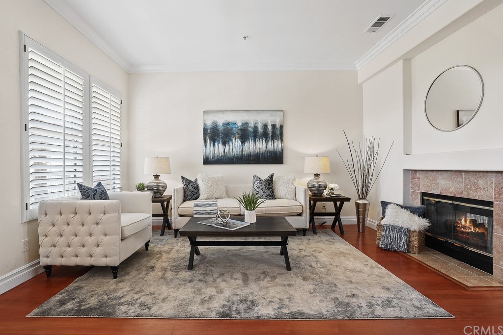 2886 Player Lane Tustin, CA 92782 - Photo 1 of 1 Gorgeous entertainers living room with crown molding, plantation shutters and a cozy fireplace