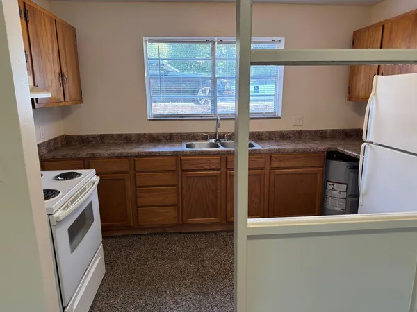 a kitchen with a stove a sink and a refrigerator