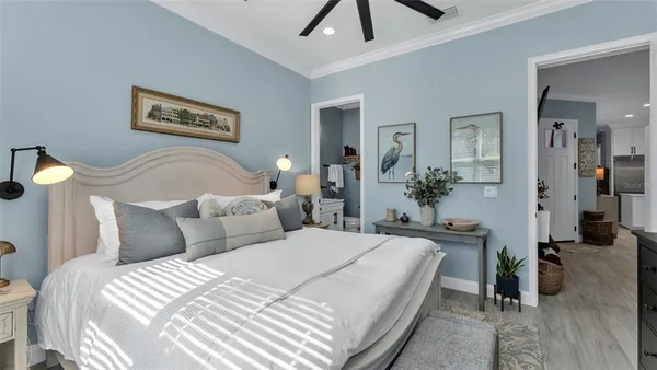 a bedroom with bed and a chandelier