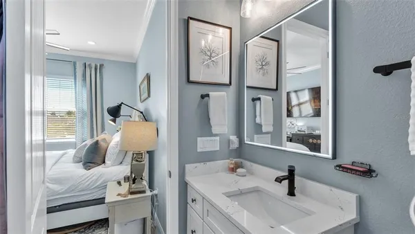 a bathroom with a sink and mirror with toilet
