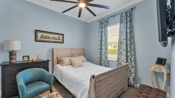 a bedroom with a bed couch and window