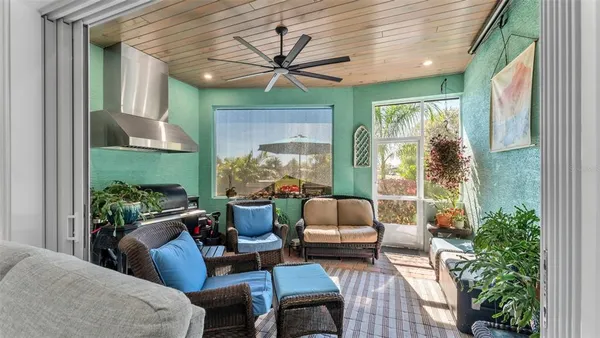 a outdoor living space with furniture potted plant and a large window