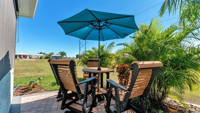 a patio with a patio table and chairs