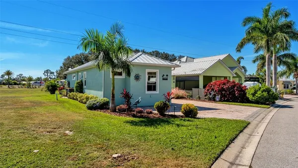 a front view of house with yard and outdoor seating