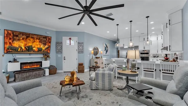 a living room with furniture a fireplace and a flat screen tv