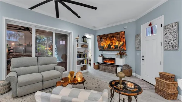 a living room with furniture a fireplace and a flat screen tv