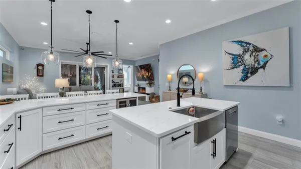 a kitchen with a sink a counter space and cabinets